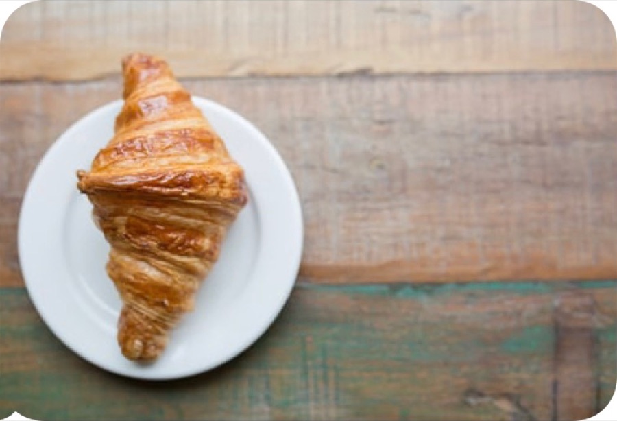 A croissant on a white plate